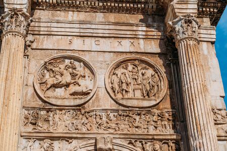 Arch of Constantine or Arco di Costantino or Triumphal arch in Rome, Italy near Coliseum, close up.
