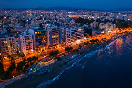 Aerial view of Limassol promenade in Cyprus at night. Drone photo of mediterranean sea resort from above.の写真素材