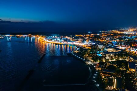 Aerial view of Paphos embankment or promenade at night with reflection of city lights in sea water. Famous Cyprus mediterranean resort.の写真素材