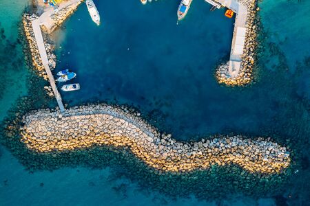 Aerial top view from drone of small bay or harbor for boats and yachts in mediterranean coastline, Cyprus travel concept.の写真素材