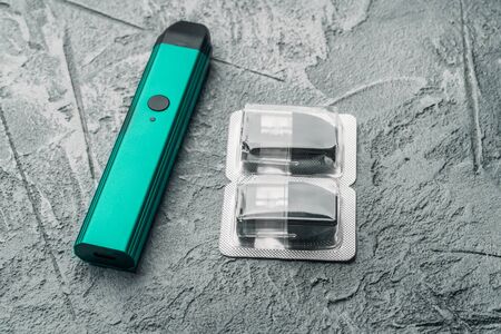 Vape pod system or pod mod with changeable cartridges close up - small size devices for inhaling...
