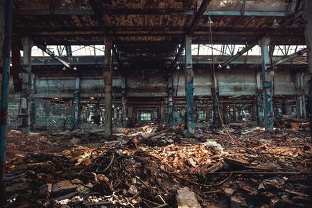 Abandoned creepy factory warehouse inside, deserted grunge industrial background.の写真素材
