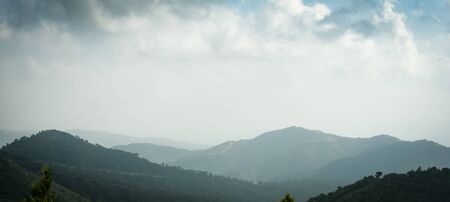 Cyprus mountain landscape panorama, aerial view in fog, mist or low lying clouds in sunlight....