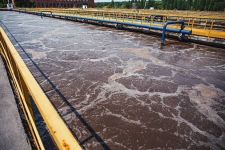 Modern wastewater and sewage treatment plant with aeration tanks, close up.