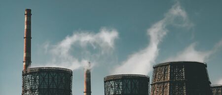 Metallurgical factory with chimneys and smog. Pollution and industry background, panoramic image.