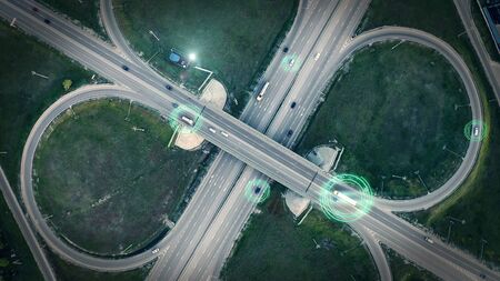 GPS navigation and autonomous driverless transportation concept. Aerial view of transport junction with cars and trucks driving with digital green circles, future global technology on roads.の写真素材
