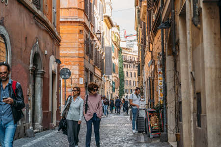 Rome street with beautiful old Italian houses and tourists people - Rome, Italy - October 2019.のeditorial素材