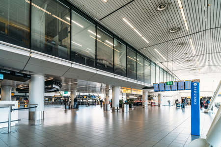 Amsterdam, Netherlands - March 2020 : Empty Amsterdam airport interior with few passengers due to Coronavirus Infection Covid-19.のeditorial素材