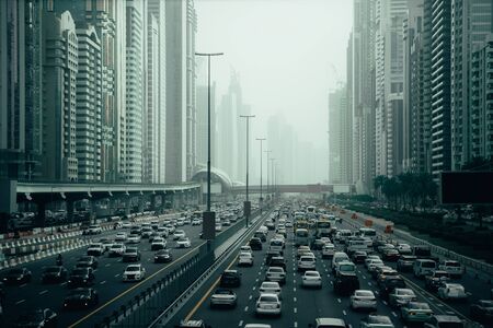 Rush hour with many cars. Traffic jam in Dubai downtown city road among skyscrapers.の写真素材