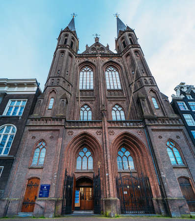 Amsterdam, Netherlands - March 2020 : Facade of De Krijtberg Kerk is Roman Catholic church in Amsterdam, located at Singel. Church was designed by Alfred Tepe and was opened in 1883.のeditorial素材