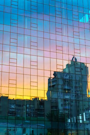 Abstract view of sunset sky reflection in modern business glass wall building.の写真素材