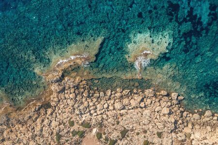 Sea aerial top view, azure water background with rocky coast in Cyprus, mediterranean landscape from above.の写真素材