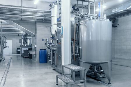 Industrial interior of beverage factory, blue toned. Food and drink production manufacturing.の写真素材