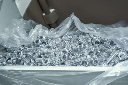 PET preforms for blowing plastic bottles in factory.