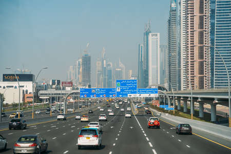 DUBAI, UAE - February 2020: Traffic on Dubai road with many cars. Sheikh Zayed road - famous highway in Dubai.のeditorial素材