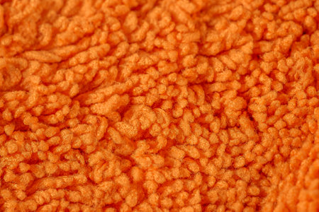 Orange Microfiber cloth surface texture background, special towel for house cleaning, moisture wiping, car drying and polishing.の写真素材