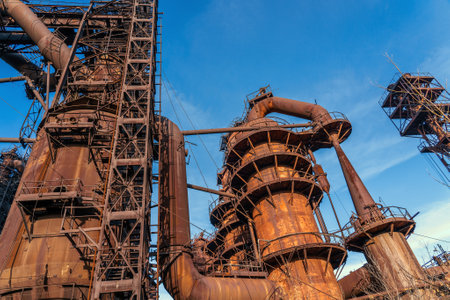 Metallurgical plant blast furnace and smokestacks. Industrial iron background.