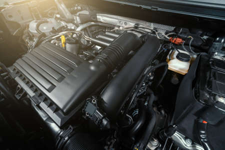 Modern turbocharged eco-friendly engine or motor under vehicle hood close up.の写真素材