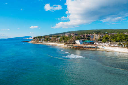 Aerial view of Divnomorskoe small sea resort town on Black Sea coast, beautiful seascape in sunny day.の写真素材