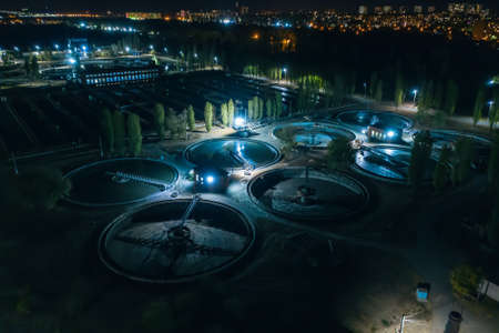 Modern wastewater treatment plant, aerial view at night. Tanks for aeration and purification of sewage.の写真素材