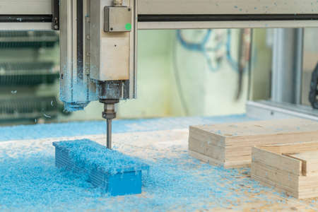CNC drill machine cutting mold from plastic, close up.