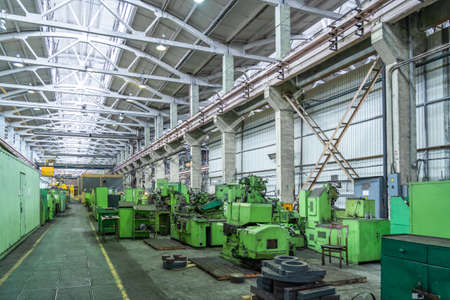 Many machine tools for metalworking in large workshop of plant. Heavy industry. Industrial interior.の写真素材
