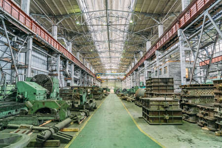 Metalworking machine tools in large workshop. Heavy industry. Metallurgical plant. Industrial interior.の写真素材