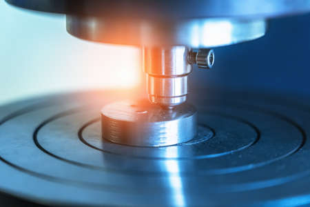 Industrial laboratory scientific equipment background in blue color. Machine for testing metal samples for strength and deformation, close up.の写真素材