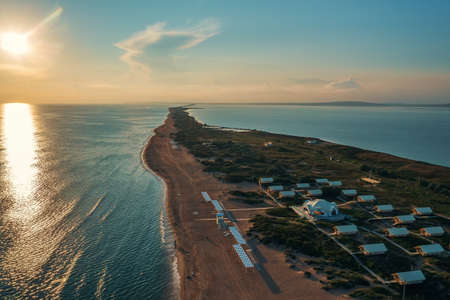 Long spit with sandy beach between sea and liman at sunset, aerial view from drone. Blagoveshchenskaya, Anapa region, Russia.の写真素材