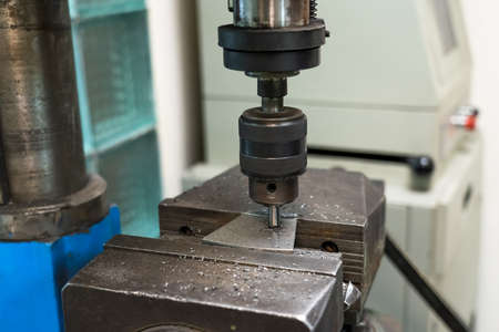 Testing of alloy steel sample at metallurgical plant close up.の写真素材