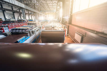 Metalworking machine for roof tile production from metal roll in modern factory workshop.の写真素材