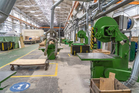 Inside interior factory workshop with stacks of wood for making molds and carpentry machine tools.の写真素材