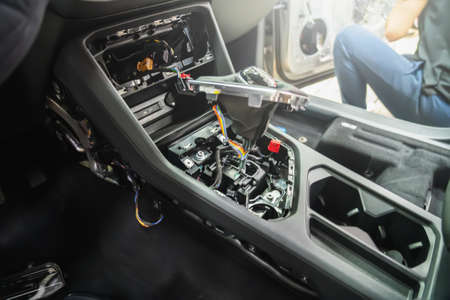 Dismantling car interior. Disassembled multimedia panel and gear lever for repair, replacement, maintenance or dry cleaning detailing.の写真素材