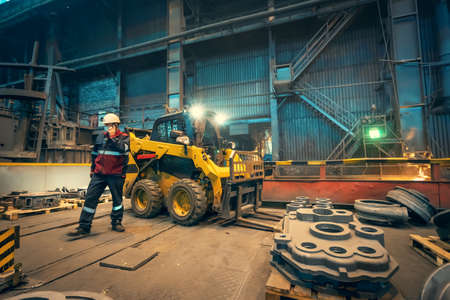 Electric forklift loader inside industrial factory warehouse interior.の写真素材