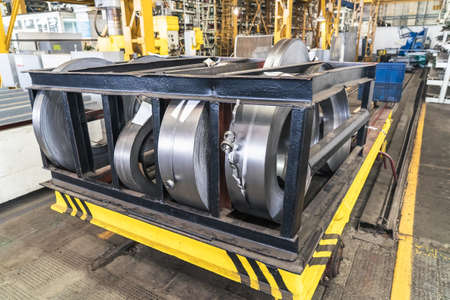 Rolls of sheet steel in factory. Galvanized steel coils for metalwork.