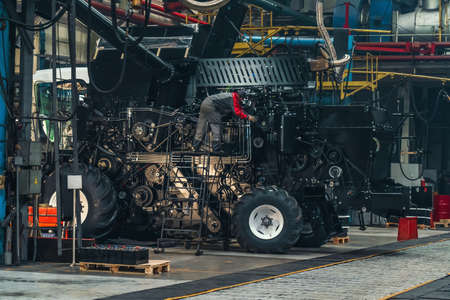 Initial adjustment of agricultural tractor or combine harvester in industrial machinery factory.の写真素材
