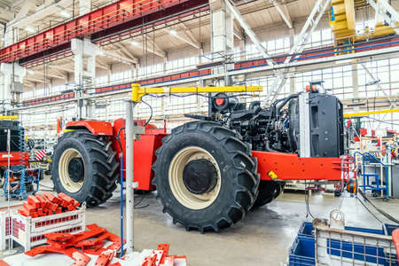 Process of assembling industrial agricultural machine in factory. Harvester or tractor production line.の写真素材