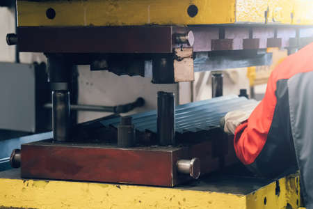 Process of forming metal sheet on press machine at factory.の写真素材