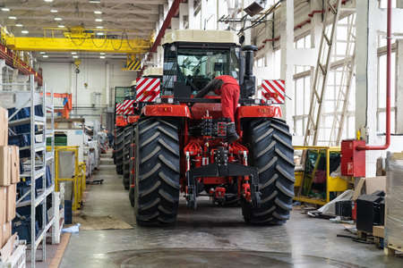Large factory building interior inside. Production line of new modern agriculture machinery.