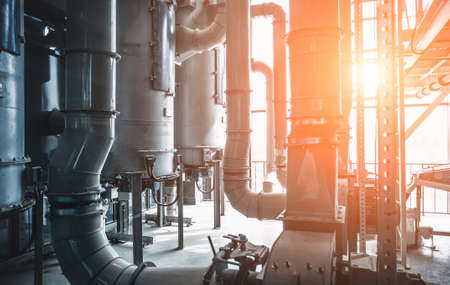 Industrial steel pipes or tubes and storage tanks or vats in beer factory as abstract industry equipment background.の写真素材