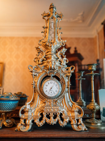 Old vintage antique bronze clock and utensil on wooden shelf, Antiques concept.の写真素材