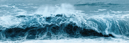 Dark blue dramatic sea storm. Ocean water bubbling near coast shore with lot of foam.