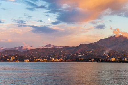 Beautiful natural seascape at sunset time with bright colorful clouds over mountains and sea.の写真素材