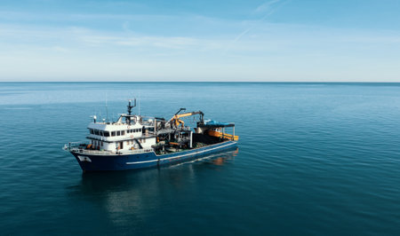 Fishing boat aerial view from drone on sea surface. Fishing and seafood industry.の写真素材