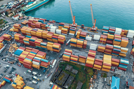 Container yard in cargo logistic port. Freight transportation and global shipping. Container cranes...