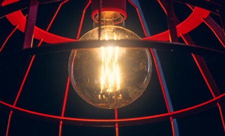 Modern glowing lamp bulb in vintage retro style close up.