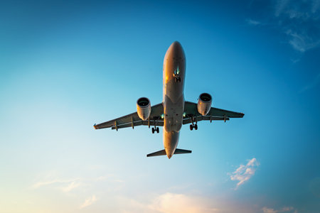 Commercial airplane jet fly at dramatic cloud sky background. Travel transportation concept.