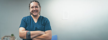 Portrait of smiling female doctor or veterinarian in uniform in clinic. Friendly woman medic looks at camera and smile, horizontal banner image with copy space for text.の写真素材