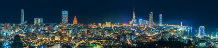 Batumi night cityscape wide panorama with modern hotels, tower buildings on Black Sea coast, Georgia. View from upper station of cable car located on mountain.の写真素材