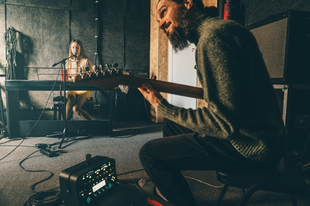 Musicians rehearsing in sound recording studio. Music band repetition.の写真素材